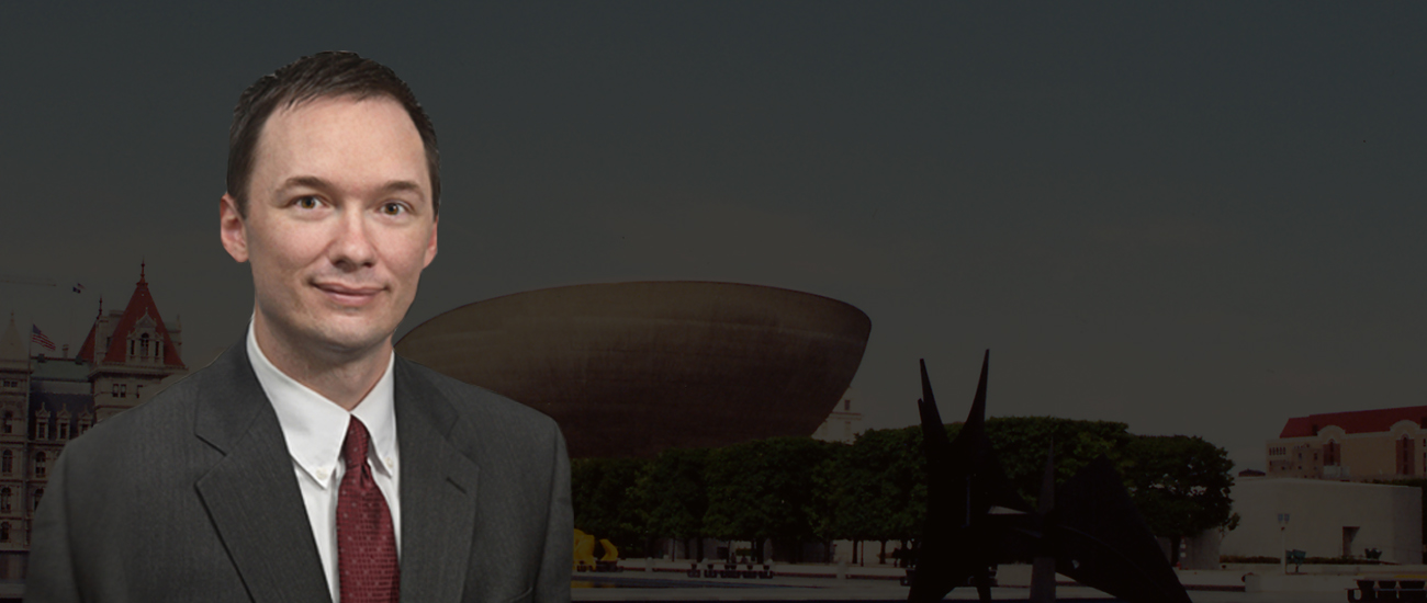 Photograph of Steven R. Dolson with a park in the background, the park features a dark filter.