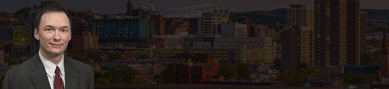 Attorney Steven R. Dolson with the Syracuse skyline in the background
